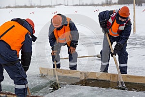 Sailors work at the lane with a fenced wooden formwork