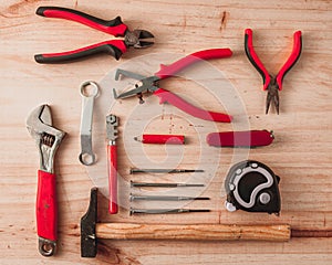 Working red tools on wooden background. Top view photo