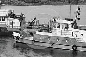 Working on river tugs in bad weather, rain