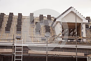 working on the roof sheeting and outriggers or ladder of a new, two story, commercial apartment building