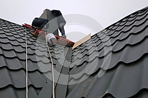 Working with roofing material, metal roof, hand tools screwdriver