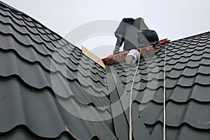 Working with roofing material, metal roof, hand tools screwdriver