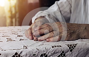 Working senior aged hands of woman after work closeup, lying on table