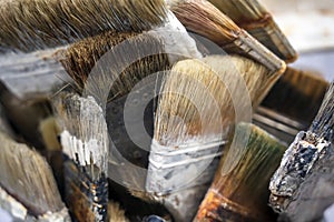 Working set of paint brushes from natural bristles with layering of paint from multiple use