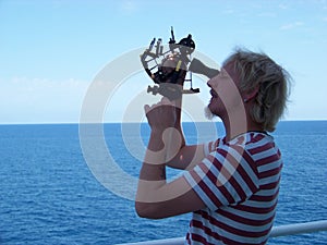 Working with sextant on board of merchant ship at noon time photo