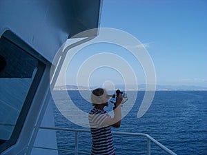 Working with sextant on merchant ship at sea