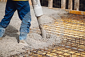 Working site concrete pouring in castings on Reinforcing steel Bars at construction site