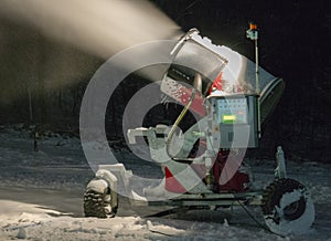 Working snow cannon at night. Snow gun in operation during the night on ski slope.
