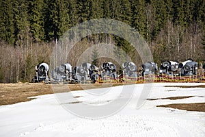 on-working snow generator on a slope without snow gear at a resort on a sunny day. Active recreation