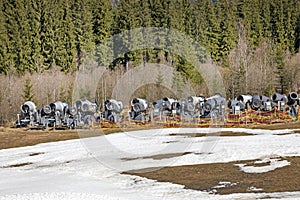 on-working snow generator on a slope without snow gear at a resort on a sunny day. Active recreation