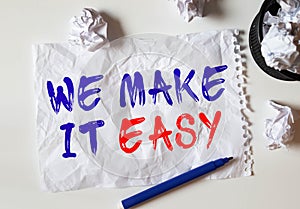 Working space. Green tea and text in notepad: We make is easy