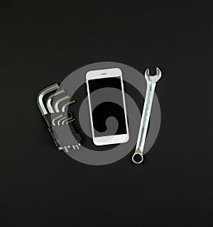 Working square concept, a set of tools and a smartphone on a black background for text, flat lay, copy space, top view