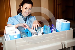 Working staff arranging toiletries in a wheel cart photo