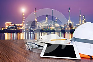 Working table engineer with tablet and tools in oil refinery industry