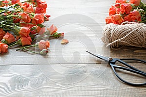 Working table florista.Preparation a bouquet of orange shrub roses. photo