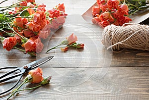 Working table florista.Preparation a bouquet of orange shrub roses. photo