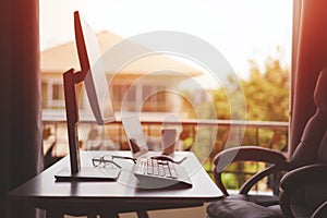 Working table at Home with Computer Monitor and Laptop Computer