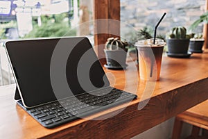 Working tablet computer in coffee cafe. Concept of freelance creative work.