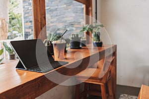 Working tablet computer in coffee cafe. Concept of freelance creative work.