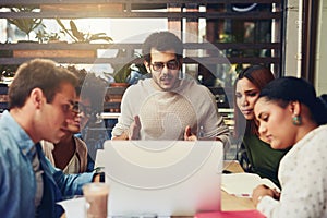 Working together is best for the company. designers having a meeting at a coffee shop.