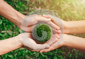 Working together to protect the environment Earth Day Two hands hold the two green worlds together. Environment and reduce global