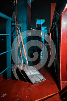 A working tool stands on the deck of a cargo ship. Portside lighting along the entire ship. Shovels. Cargo ship