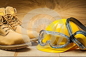 Working tools. construction concept. yellow construction helmet earphones working boots