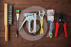 Working tools laid out on a wooden background