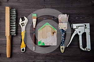 Working tools laid out on a wooden background, concept of building a house