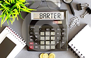 Working tools in office with calculator text loss, phone, coins, notebook with text BARTER