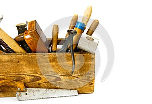 Working tools in an old box on white background