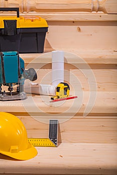 Working tools on setps of wooden ladder
