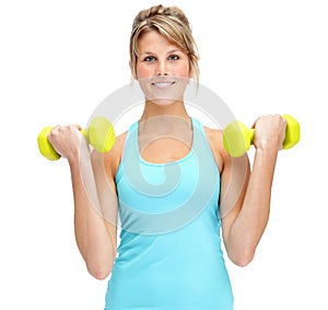 Working towards her best health. Attractive young woman in sportswear lifting dumbbells while isolated on white.