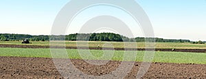 Tractor working in spring field, Lithuania