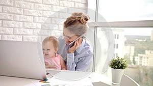 Working woman with baby speaking phone. Business mom with child