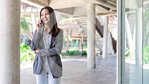 Working woman concept a working woman with smiley face speaking on the phone with her business partner