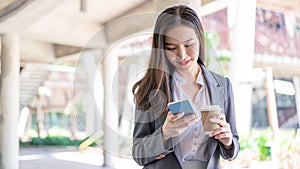 Working woman concept a young female manager attending video conference and holding a cup of coffee