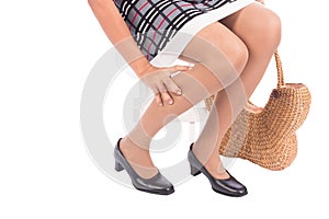 Working woman holding her hurting ankle