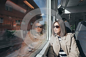 A working woman travels and enjoy the beautiful view in train at