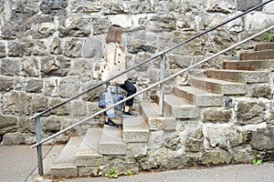 Working woman is walking up the stairs.