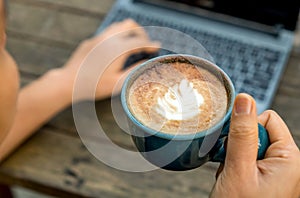 Working women with coffee late in the hand,Women are using laptops for work.