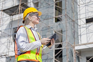 Working women Smart construction engineer caucasian female architect looking under construction building project