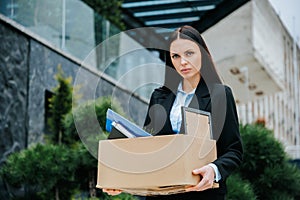 Workless and Alone Woman Outside with Box of Belongings