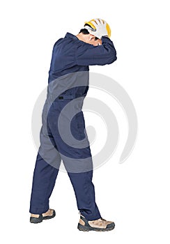 Workman with blue coveralls and hardhat in a uniform with clipping path