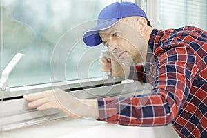 Workman checking aluminium window frame