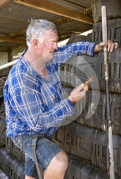 Workman checks mobile phone.