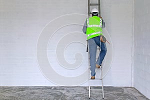 Workman climbing a ladder