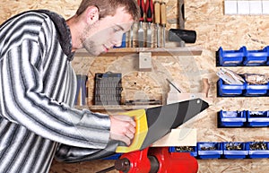 Workman with handsaw