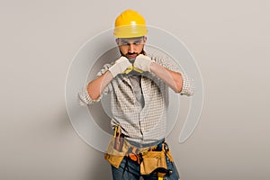 Workman in hardhat and gloves with