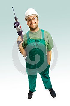 Workman in helmet with drill photo